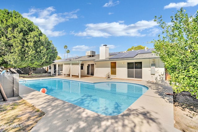 view of swimming pool featuring cooling unit and a patio