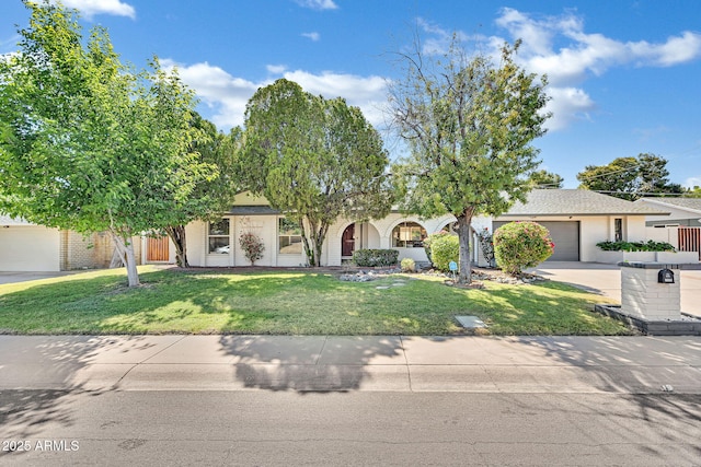 obstructed view of property featuring a garage and a front lawn