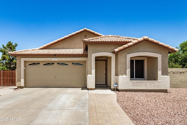 1583 N Constellation Ct, Gilbert, AZ 85234 - mediterranean / spanish home featuring driveway, an attached garage, stucco siding, and a tiled roof