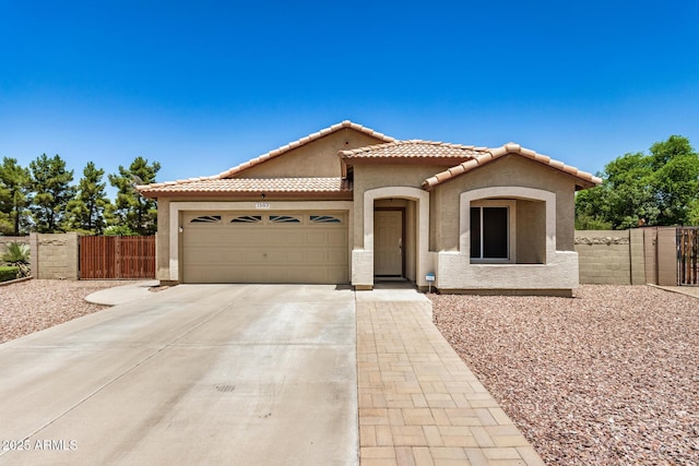 1583 N Constellation Ct, Gilbert, AZ 85234 - mediterranean / spanish-style house with a gate, an attached garage, concrete driveway, and stucco siding