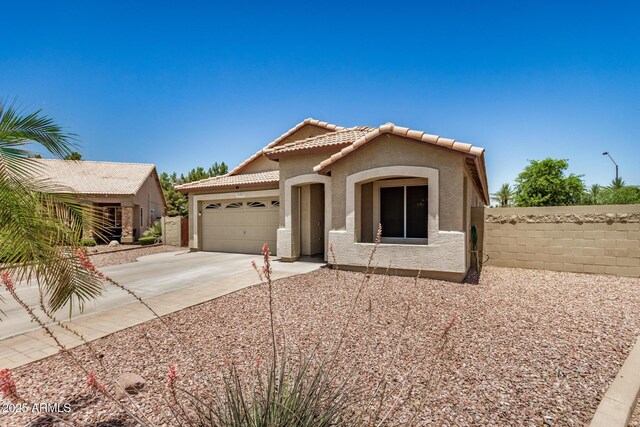 1583 N Constellation Ct, Gilbert, AZ 85234 - mediterranean / spanish-style house with stucco siding, an attached garage, concrete driveway, and a tiled roof
