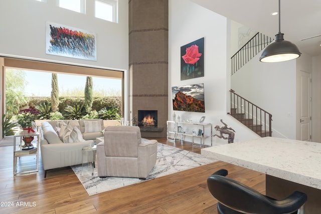 living room featuring hardwood / wood-style floors, a wealth of natural light, and a high ceiling