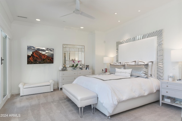 bedroom with ceiling fan, light carpet, and crown molding