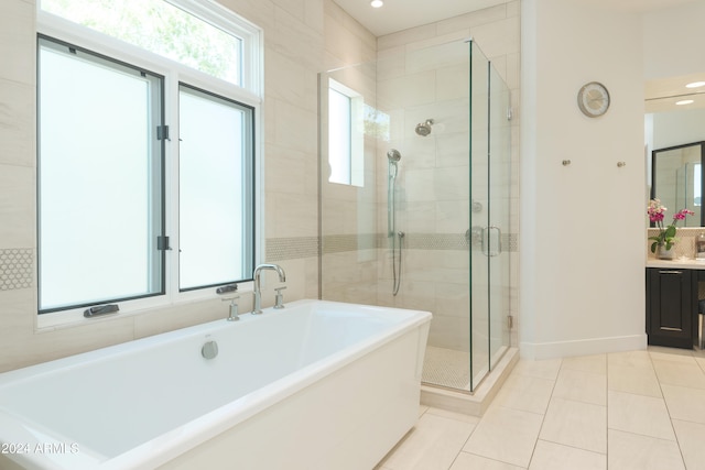 bathroom featuring tile walls, separate shower and tub, vanity, and tile flooring