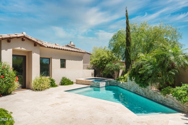 view of swimming pool with a patio and an in ground hot tub