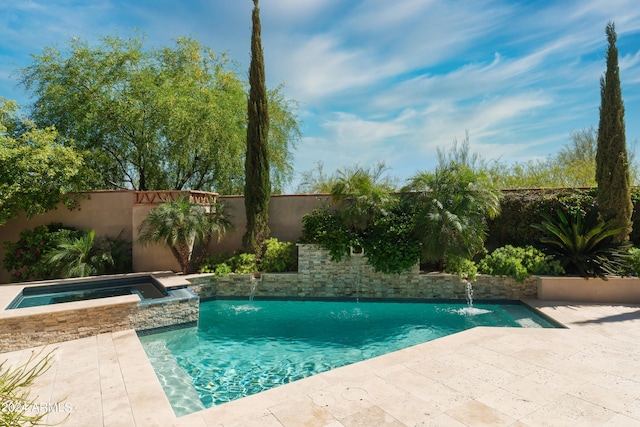 view of pool featuring pool water feature and an in ground hot tub