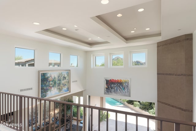 hallway with a raised ceiling