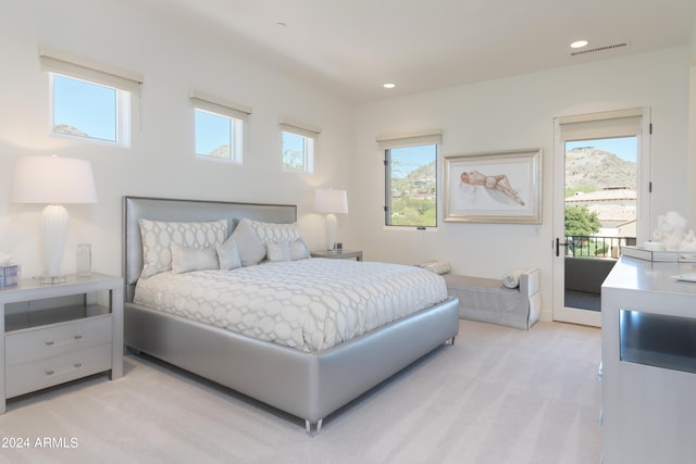 carpeted bedroom with access to outside and multiple windows