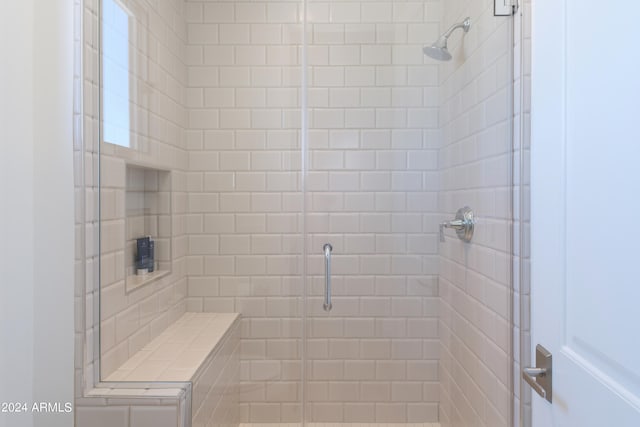 bathroom featuring a shower with shower door