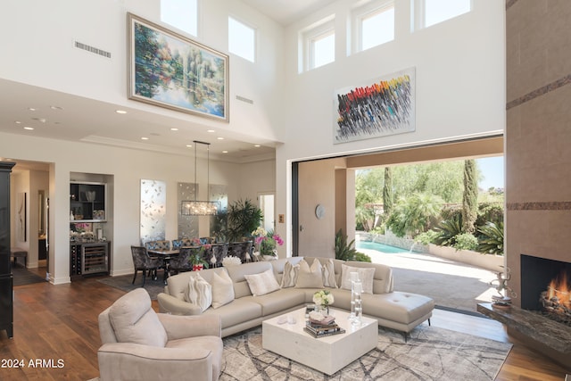 living room with hardwood / wood-style floors, a wealth of natural light, and a high ceiling