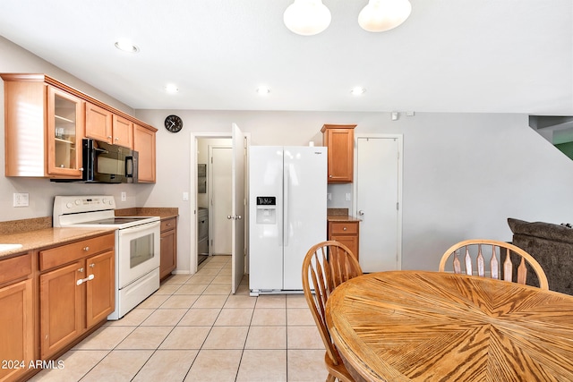 kitchen with white appliances and light tile patterned floors