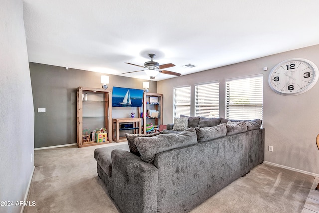 living room featuring ceiling fan and light colored carpet