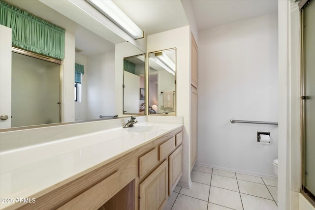 full bathroom featuring toilet, vanity, baseboards, and tile patterned floors