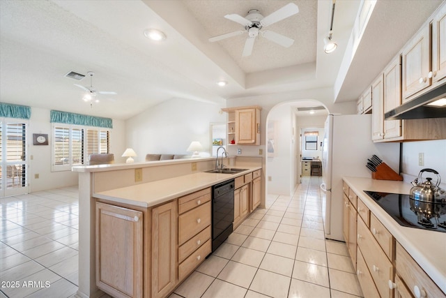 kitchen with visible vents, arched walkways, black appliances, light brown cabinets, and a sink