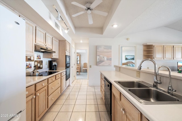 kitchen with black appliances, light brown cabinetry, a sink, and under cabinet range hood