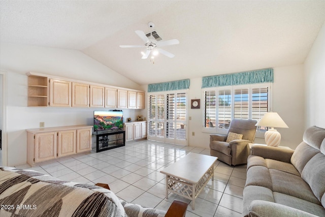 living area with light tile patterned floors, ceiling fan, visible vents, and vaulted ceiling