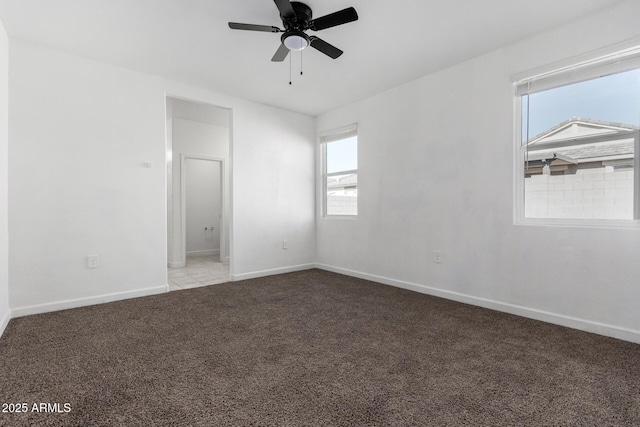 carpeted empty room featuring ceiling fan