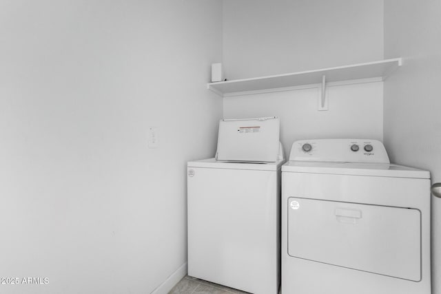 laundry area featuring washer and dryer and light tile patterned floors