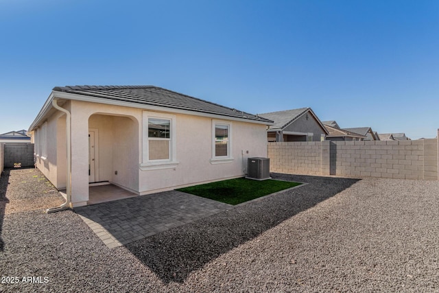 back of house with central air condition unit and a patio