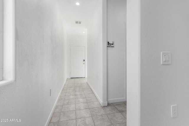 hall with light tile patterned floors