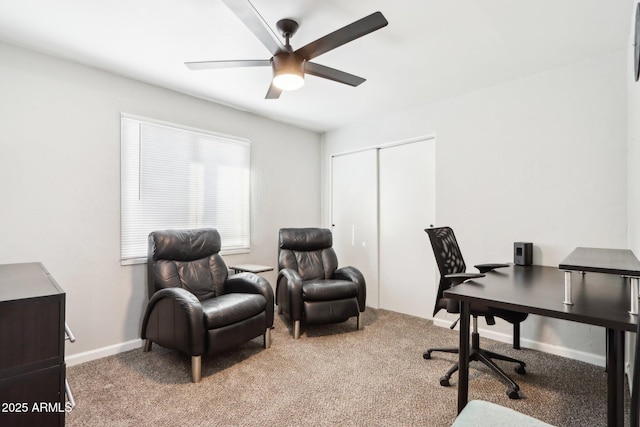 carpeted office space featuring ceiling fan