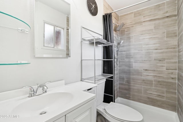 bathroom featuring vanity, a shower with curtain, and toilet