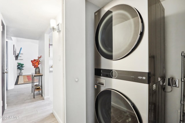 laundry area featuring stacked washer / drying machine