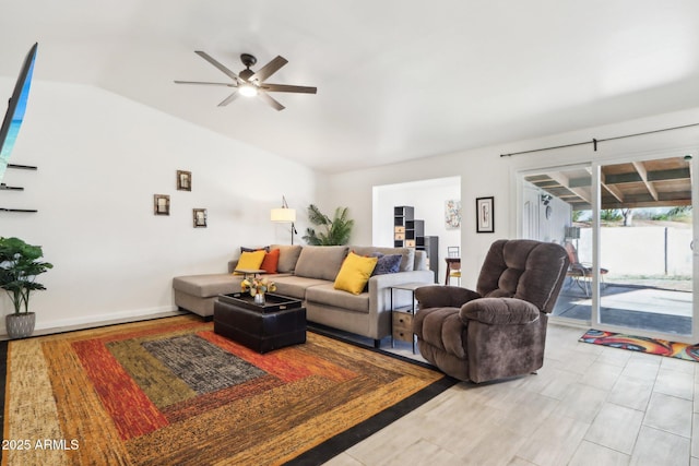 living room featuring vaulted ceiling and ceiling fan