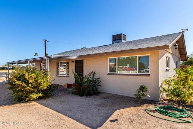 single story home featuring central air condition unit