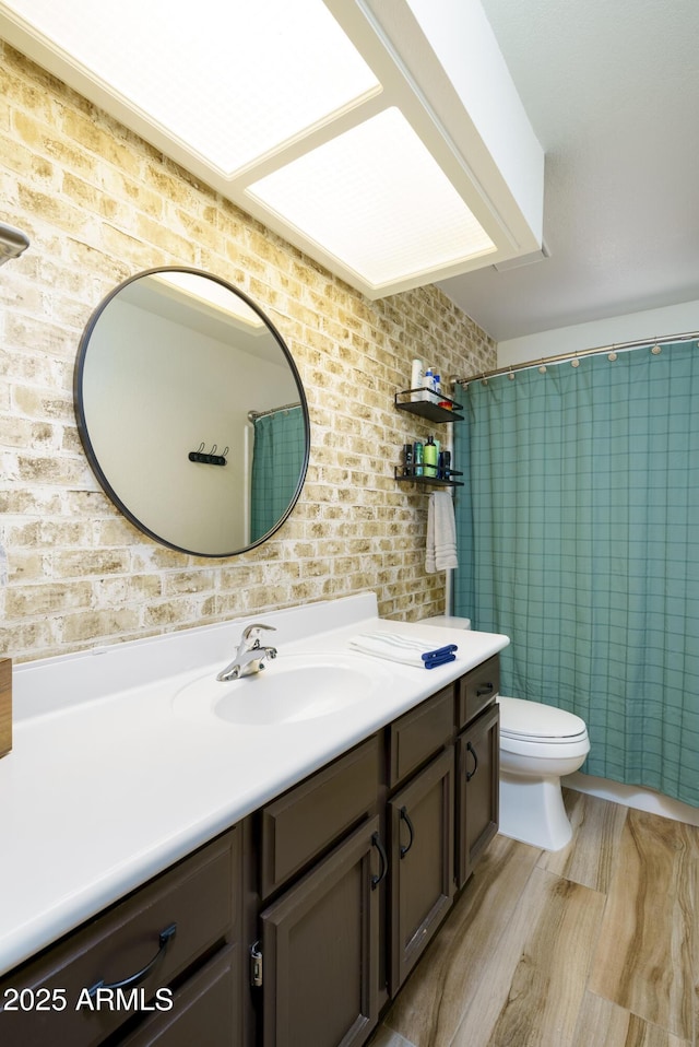 bathroom with vanity, toilet, and curtained shower