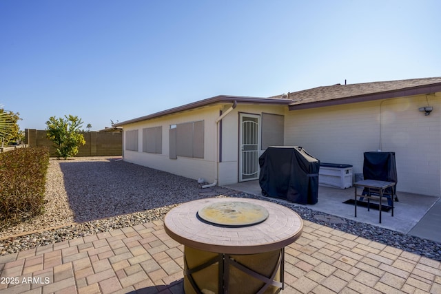 exterior space with a patio and an outdoor fire pit