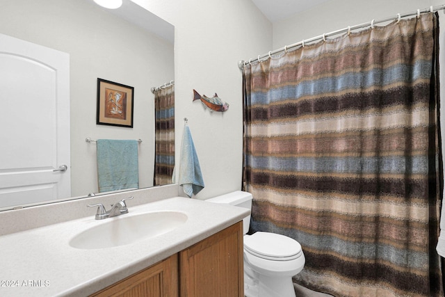 bathroom featuring walk in shower, vanity, and toilet