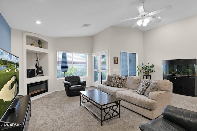 living room with ceiling fan, built in features, and light colored carpet