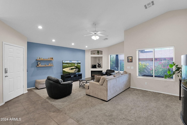 living room with tile patterned floors, ceiling fan, built in features, and lofted ceiling