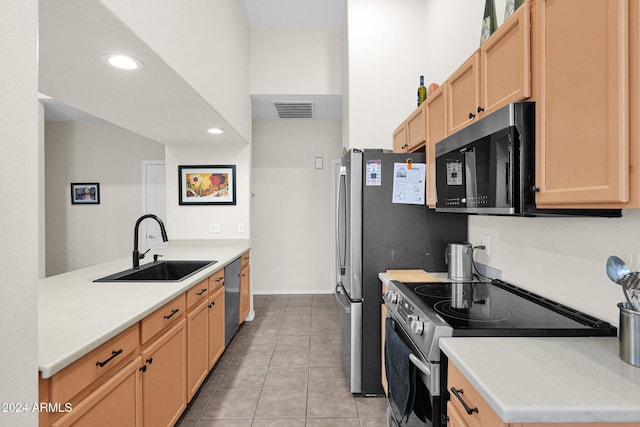 kitchen with light brown cabinets, light tile patterned floors, sink, and appliances with stainless steel finishes