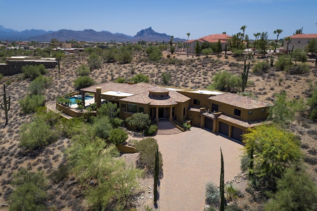 birds eye view of property with a mountain view