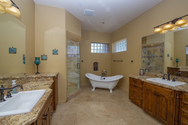 bathroom with vanity and separate shower and tub