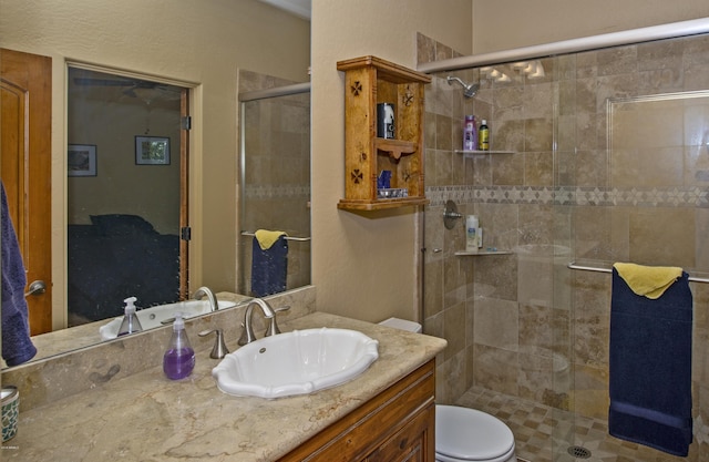 bathroom with vanity, toilet, and a shower with shower door