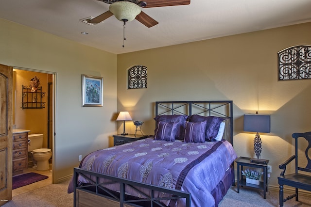 bedroom featuring light carpet, ensuite bath, and ceiling fan