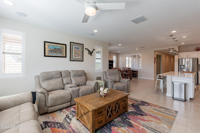 tiled living room featuring ceiling fan