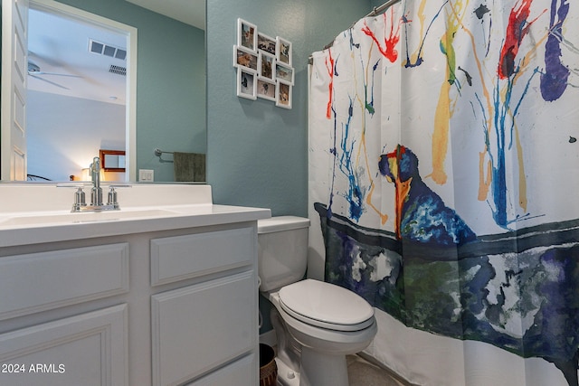 bathroom with walk in shower, vanity, and toilet