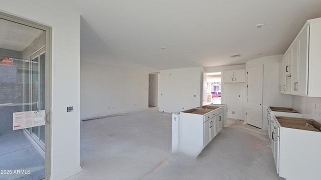 kitchen with a kitchen island and white cabinets