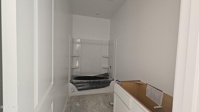 bathroom featuring shower / bathing tub combination and concrete floors