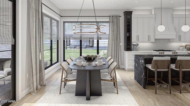 dining area with an inviting chandelier and light hardwood / wood-style floors