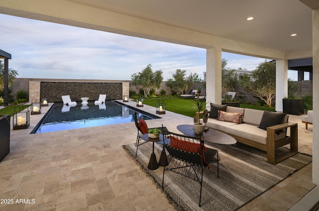 view of pool featuring an outdoor living space, a fenced in pool, a lawn, and a patio area