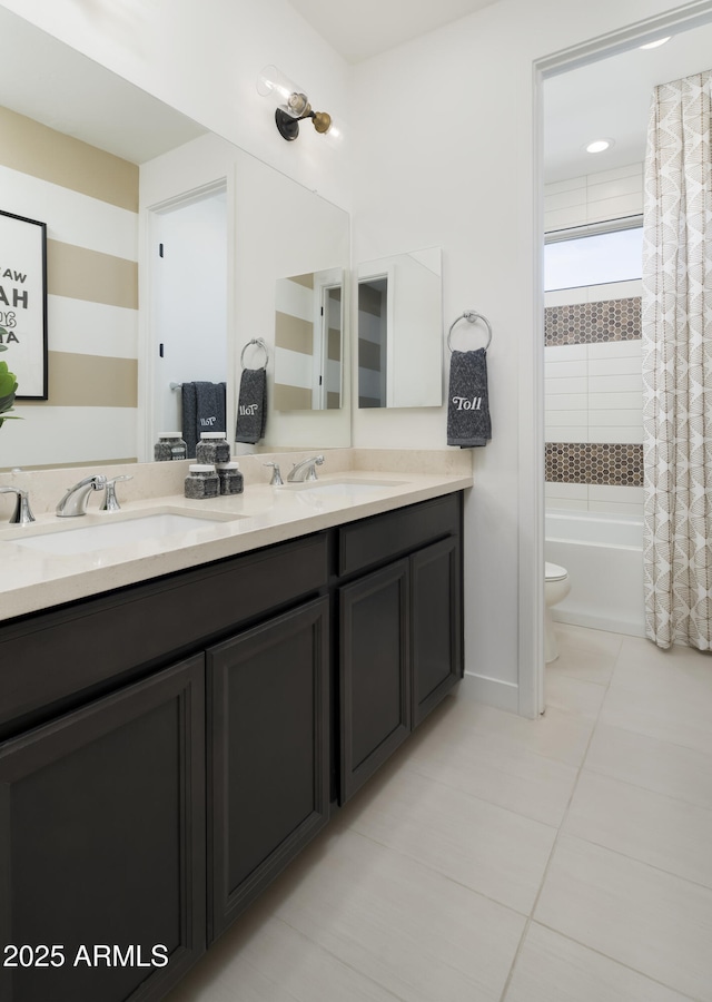 bathroom featuring tile patterned floors, toilet, shower / bath combo with shower curtain, and a sink