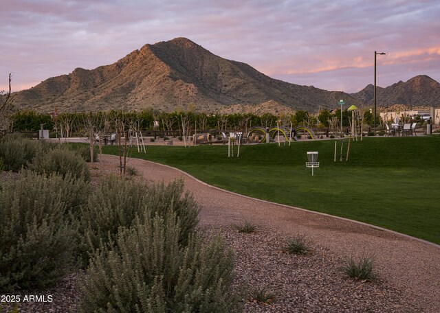 view of community with a lawn and a mountain view