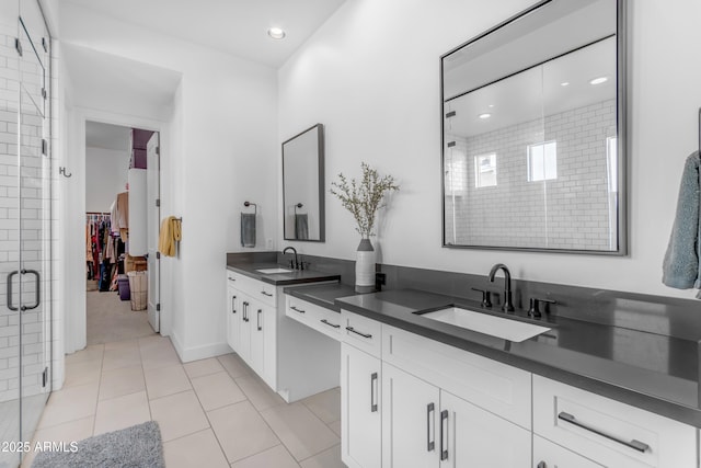 full bath with recessed lighting, a shower stall, tile patterned flooring, a spacious closet, and vanity