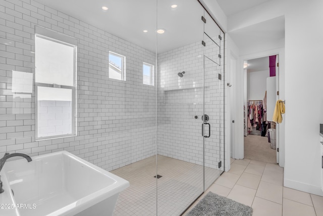 bathroom featuring a stall shower, a sink, recessed lighting, tile patterned flooring, and a soaking tub