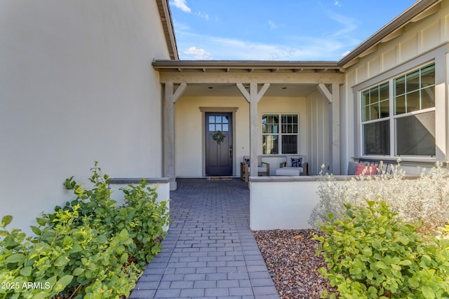 entrance to property featuring board and batten siding and a porch